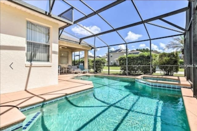 214 Tupelo Cir, Davenport, FL 33897 - view of swimming pool with a patio, a pool with connected hot tub, and glass enclosure
