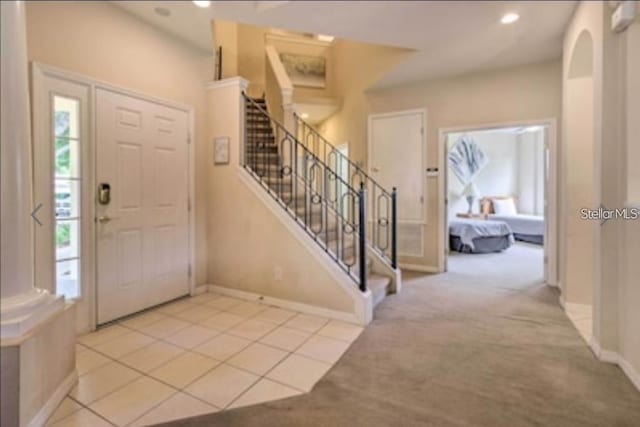 214 Tupelo Cir, Davenport, FL 33897 - entrance foyer with stairway, carpet floors, baseboards, arched walkways, and recessed lighting