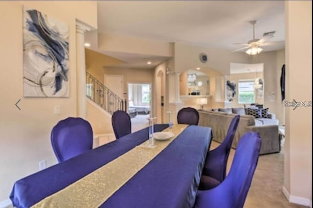 214 Tupelo Cir, Davenport, FL 33897 - dining room with healthy amount of natural light, a ceiling fan, stairs, and carpet