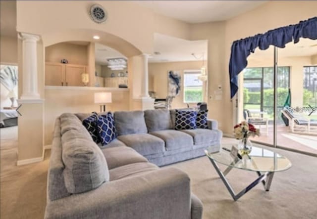 214 Tupelo Cir, Davenport, FL 33897 - living area with decorative columns, carpet, and arched walkways
