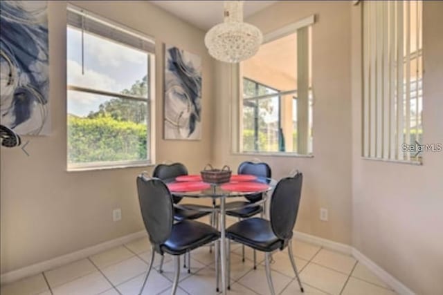 214 Tupelo Cir, Davenport, FL 33897 - dining room with a chandelier, plenty of natural light, baseboards, and tile patterned floors