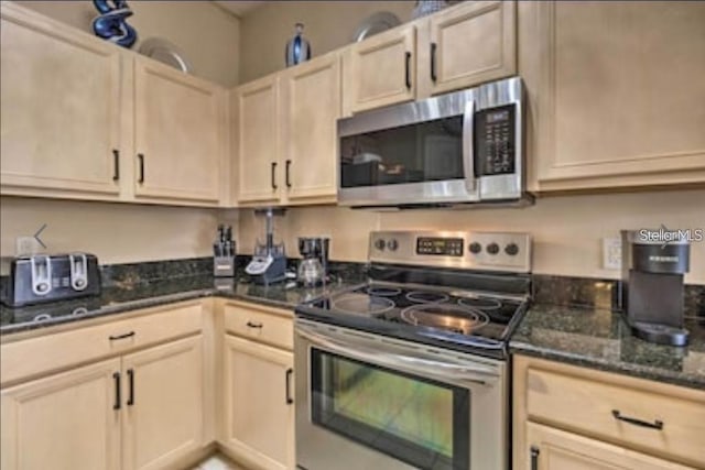 214 Tupelo Cir, Davenport, FL 33897 - kitchen with stainless steel appliances and dark stone countertops