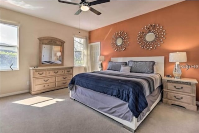 214 Tupelo Cir, Davenport, FL 33897 - bedroom with light colored carpet, baseboards, and a ceiling fan