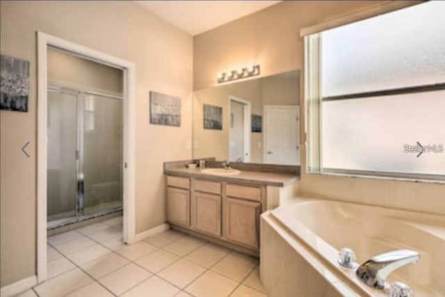 214 Tupelo Cir, Davenport, FL 33897 - full bath with a stall shower, vanity, tile patterned flooring, and a bath