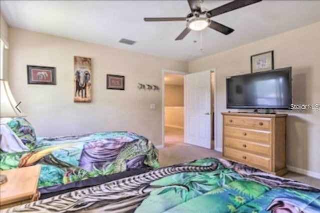 214 Tupelo Cir, Davenport, FL 33897 - carpeted bedroom with ceiling fan and baseboards