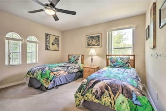 214 Tupelo Cir, Davenport, FL 33897 - bedroom featuring carpet flooring, a ceiling fan, and baseboards