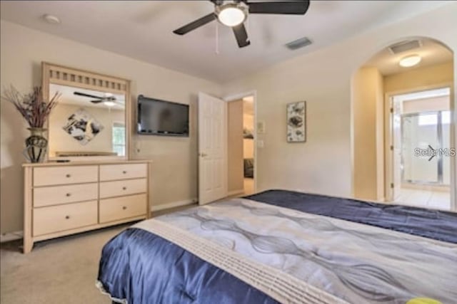 214 Tupelo Cir, Davenport, FL 33897 - bedroom with arched walkways, light carpet, baseboards, and a ceiling fan