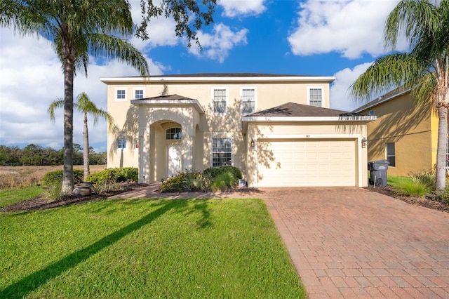389 Yellow Snapdragon Dr, Davenport, FL 33837 - view of front of house with stucco siding, decorative driveway, a garage, and a front yard