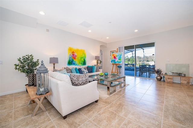 389 Yellow Snapdragon Dr, Davenport, FL 33837 - living area featuring arched walkways, light tile patterned floors, recessed lighting, and baseboards