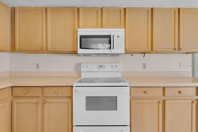 572 Floral Dr, Kissimmee, FL 34743 - kitchen featuring white appliances, light brown cabinets, and light countertops