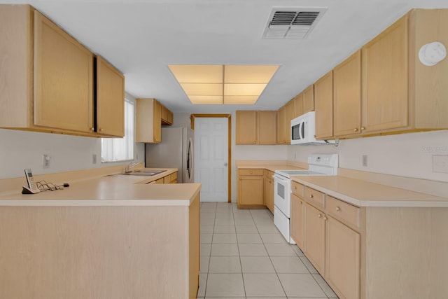 572 Floral Dr, Kissimmee, FL 34743 - kitchen featuring white appliances, a sink, a peninsula, light brown cabinetry, and light tile patterned floors