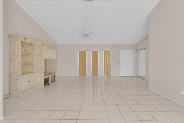 572 Floral Dr, Kissimmee, FL 34743 - unfurnished living room with ceiling fan, baseboards, light tile patterned floors, and high vaulted ceiling