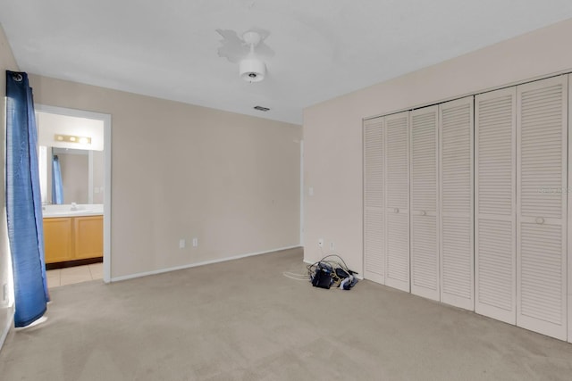 572 Floral Dr, Kissimmee, FL 34743 - unfurnished bedroom featuring light colored carpet, a closet, and connected bathroom