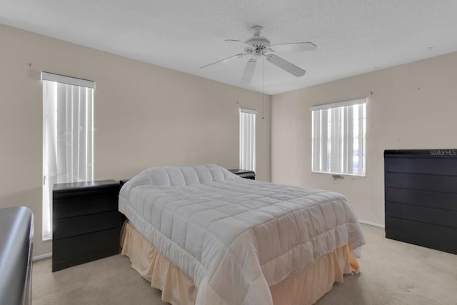 572 Floral Dr, Kissimmee, FL 34743 - bedroom featuring light carpet, multiple windows, and baseboards