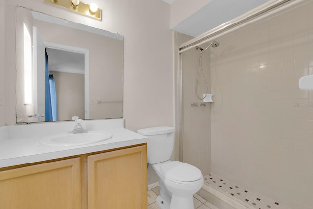572 Floral Dr, Kissimmee, FL 34743 - bathroom featuring a shower stall, toilet, vanity, and tile patterned floors