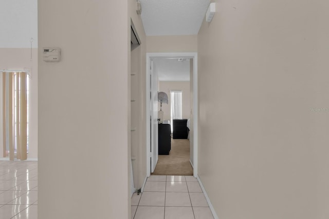 572 Floral Dr, Kissimmee, FL 34743 - corridor featuring light tile patterned flooring and baseboards