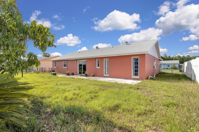 572 Floral Dr, Kissimmee, FL 34743 - rear view of house featuring a patio area