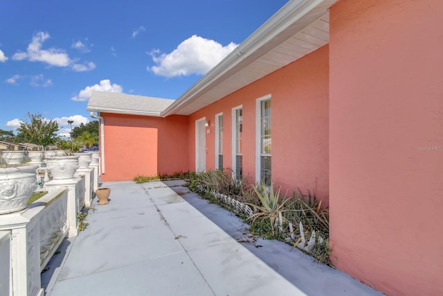 572 Floral Dr, Kissimmee, FL 34743 - view of home's exterior with stucco siding and a patio