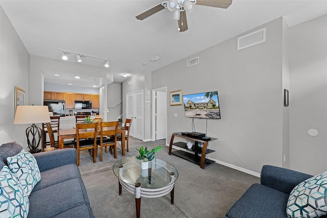 4551 Jonafree Ln Unit 103, Kissimmee, FL 34746 - carpeted living area featuring a ceiling fan and baseboards