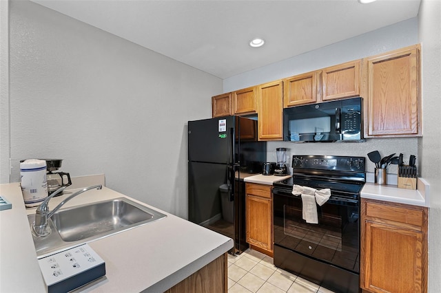 4551 Jonafree Ln Unit 103, Kissimmee, FL 34746 - kitchen featuring black appliances, a sink, light tile patterned floors, light countertops, and recessed lighting