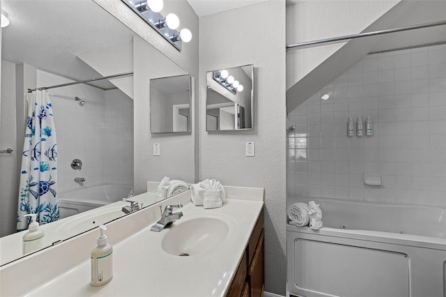 4551 Jonafree Ln Unit 103, Kissimmee, FL 34746 - full bath with a combined bath / shower with jetted tub, a textured wall, and vanity