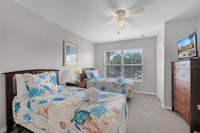 4551 Jonafree Ln Unit 103, Kissimmee, FL 34746 - bedroom featuring carpet, baseboards, a textured ceiling, and ceiling fan