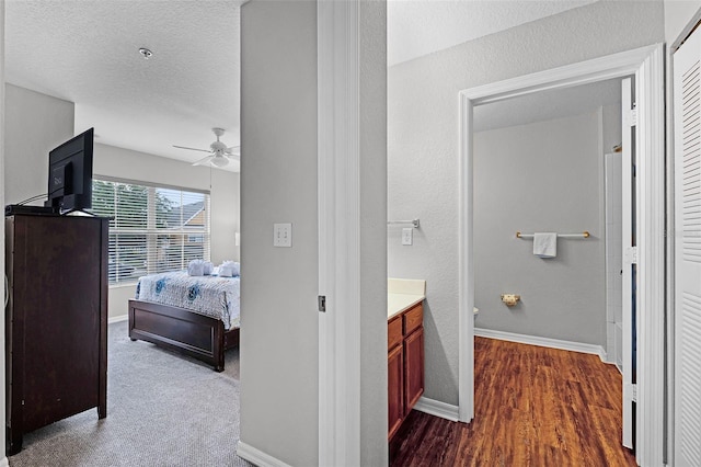 4551 Jonafree Ln Unit 103, Kissimmee, FL 34746 - bedroom featuring baseboards, dark wood-style flooring, and a ceiling fan