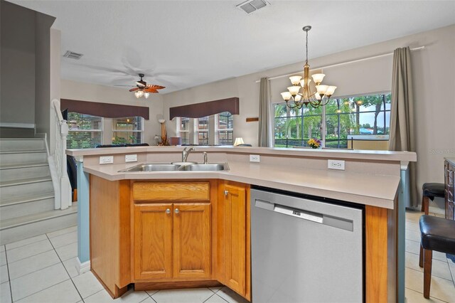 3015 Yellow Lantana Ln, Kissimmee, FL 34747 - kitchen featuring dishwasher, light countertops, a sink, a chandelier, and hanging light fixtures