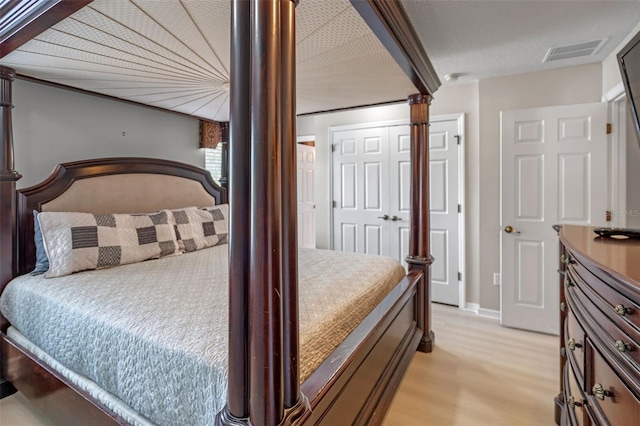 3015 Yellow Lantana Ln, Kissimmee, FL 34747 - bedroom featuring light wood-style flooring and ornate columns