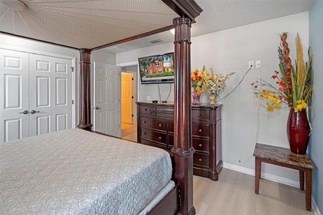 3015 Yellow Lantana Ln, Kissimmee, FL 34747 - bedroom with decorative columns, light wood finished floors, a closet, and baseboards