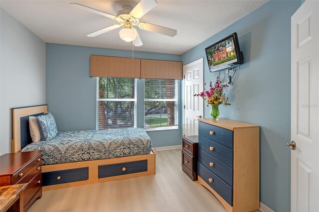 3015 Yellow Lantana Ln, Kissimmee, FL 34747 - bedroom with light wood-style floors, baseboards, and a ceiling fan