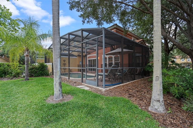 3015 Yellow Lantana Ln, Kissimmee, FL 34747 - rear view of property featuring a patio area, a yard, an outdoor pool, and glass enclosure