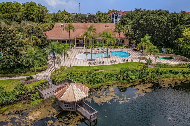 3015 Yellow Lantana Ln, Kissimmee, FL 34747 - back of house featuring an outdoor pool, a patio area, and a water view