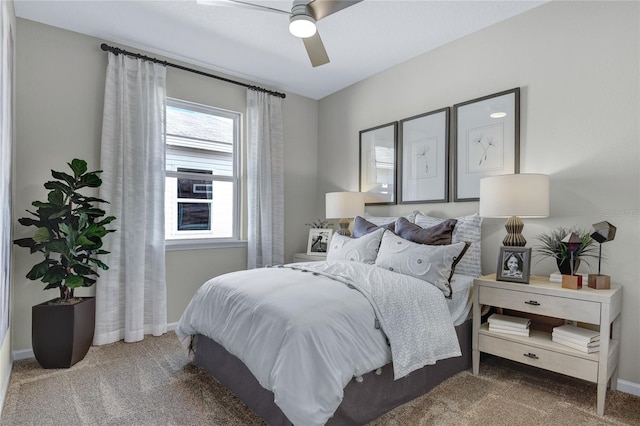 carpeted bedroom with multiple windows, baseboards, and ceiling fan