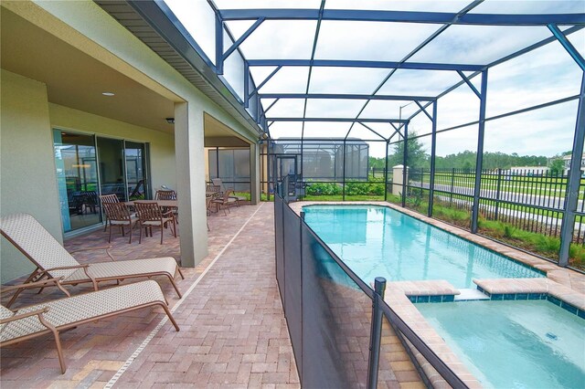 2147 Tripoli Ct, Kissimmee, FL 34747 - view of pool with a pool with connected hot tub, a patio, a lanai, and outdoor dining space