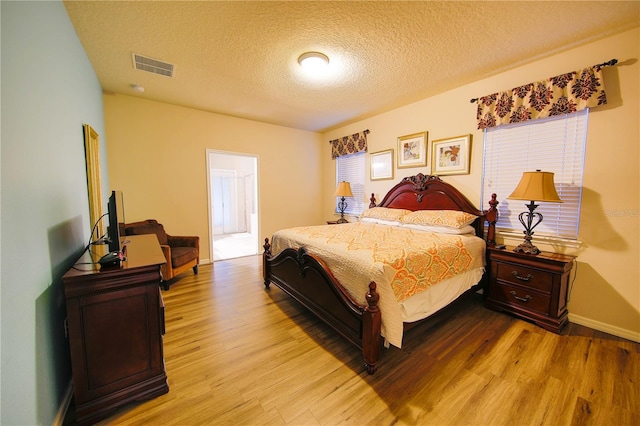 2147 Tripoli Ct, Kissimmee, FL 34747 - bedroom with wood finished floors, a textured ceiling, and baseboards