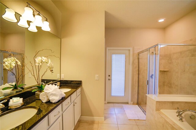 2147 Tripoli Ct, Kissimmee, FL 34747 - bathroom with tile patterned floors, a shower stall, a chandelier, and a bath