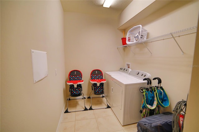 2147 Tripoli Ct, Kissimmee, FL 34747 - clothes washing area with washer and dryer, light tile patterned floors, and baseboards