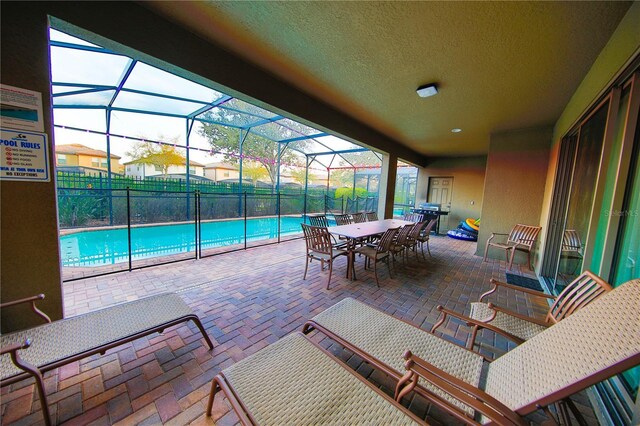 2147 Tripoli Ct, Kissimmee, FL 34747 - view of patio / terrace with outdoor dining space and glass enclosure