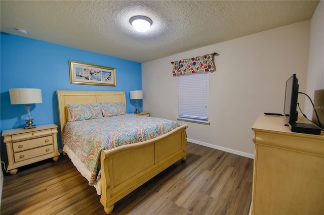 2147 Tripoli Ct, Kissimmee, FL 34747 - bedroom with wood finished floors, a textured ceiling, and baseboards