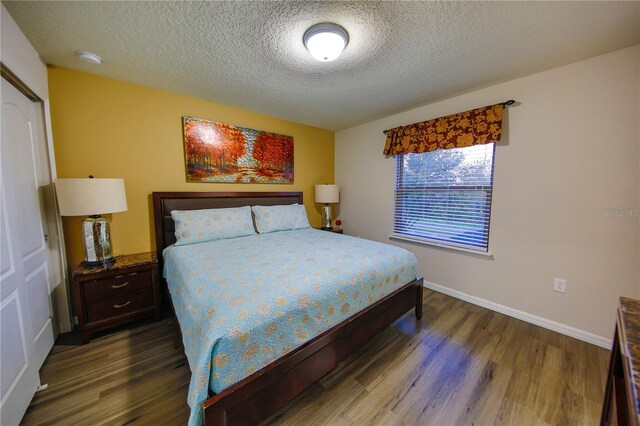 2147 Tripoli Ct, Kissimmee, FL 34747 - bedroom with dark wood-type flooring, a textured ceiling, and baseboards