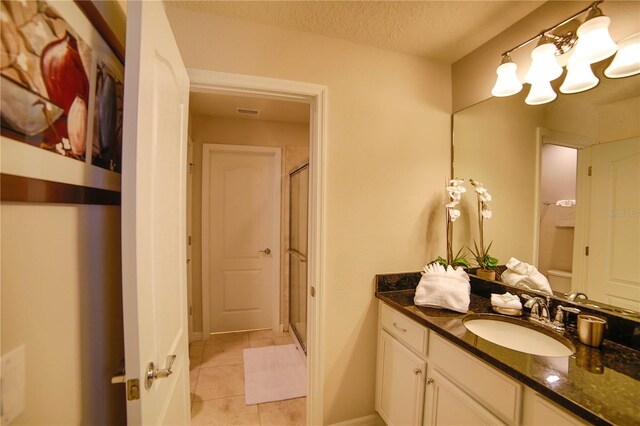 2147 Tripoli Ct, Kissimmee, FL 34747 - bathroom with vanity, a chandelier, a shower stall, tile patterned floors, and a textured ceiling