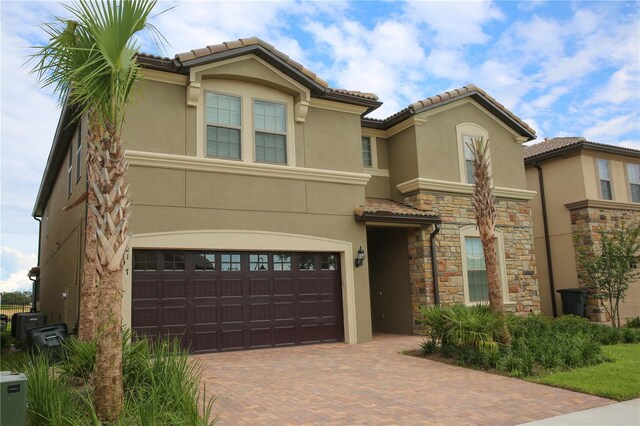 2147 Tripoli Ct, Kissimmee, FL 34747 - view of front of property with stucco siding, decorative driveway, an attached garage, and a tiled roof