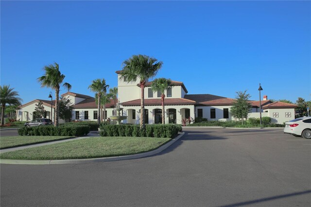 2147 Tripoli Ct, Kissimmee, FL 34747 - mediterranean / spanish-style house with a tile roof, stucco siding, and uncovered parking