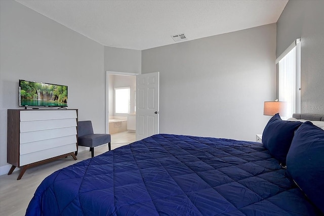 553 Bailey Cir, Davenport, FL 33897 - bedroom featuring lofted ceiling and ensuite bath