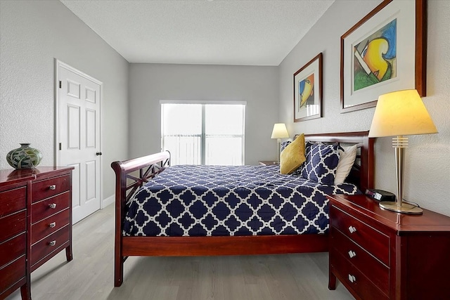 553 Bailey Cir, Davenport, FL 33897 - bedroom with wood finished floors and a textured wall