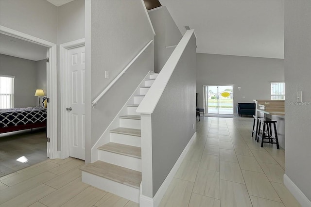 553 Bailey Cir, Davenport, FL 33897 - staircase featuring baseboards and a high ceiling
