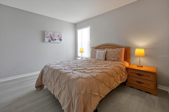 553 Bailey Cir, Davenport, FL 33897 - bedroom featuring wood finished floors, baseboards, and a textured ceiling