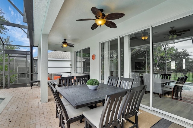 sunroom / solarium featuring ceiling fan and outdoor dining area