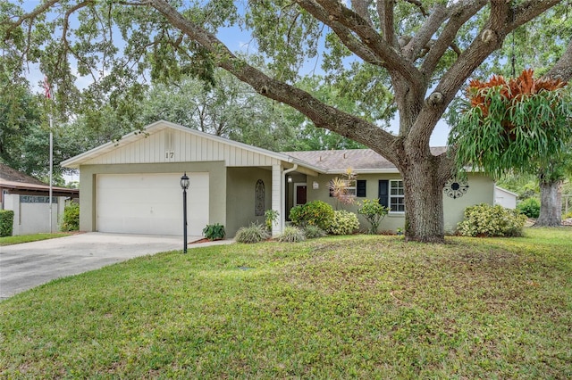 ranch-style home featuring stucco siding, an attached garage, a front yard, and concrete driveway